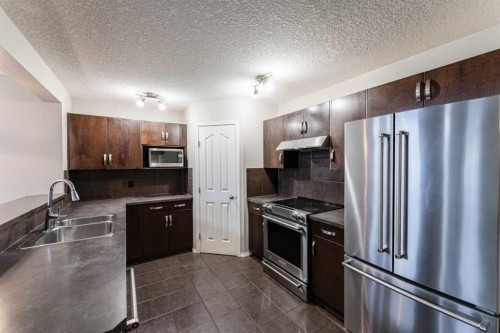 20 Bridlecrest Court Sw, Calgary, AB - Indoor Photo Showing Kitchen With Stainless Steel Kitchen With Double Sink