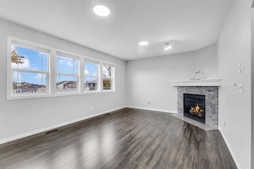 11 Saddlebrook Way Ne, Calgary, AB - Indoor Photo Showing Living Room With Fireplace