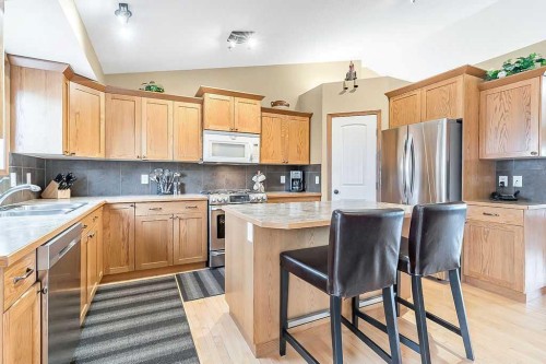 518 Sunrise Way Sw, Diamond Valley, AB - Indoor Photo Showing Kitchen With Double Sink