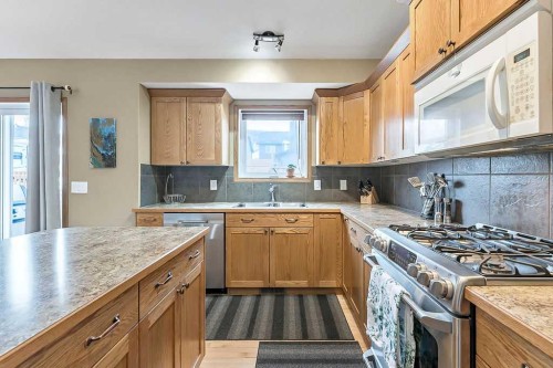 518 Sunrise Way Sw, Diamond Valley, AB - Indoor Photo Showing Kitchen With Double Sink