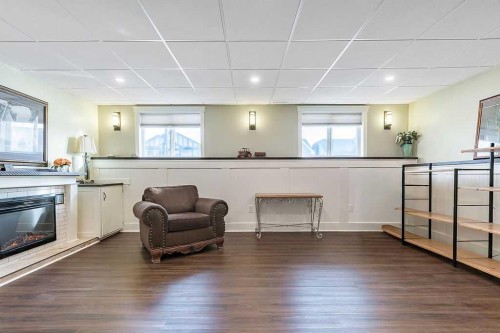 518 Sunrise Way Sw, Diamond Valley, AB - Indoor Photo Showing Other Room With Fireplace