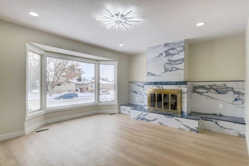 2443 42 Street Se, Calgary, AB - Indoor Photo Showing Other Room With Fireplace