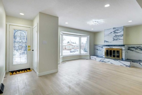 2443 42 Street Se, Calgary, AB - Indoor Photo Showing Living Room With Fireplace