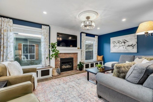 1220 Meadowbrook Drive Se, Airdrie, AB - Indoor Photo Showing Living Room With Fireplace