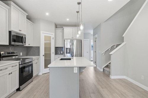 936 Reynolds Lane Sw, Airdrie, AB - Indoor Photo Showing Kitchen With Upgraded Kitchen