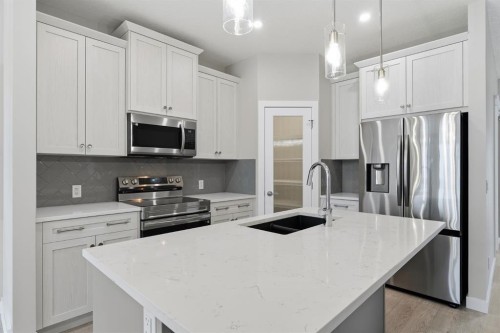 936 Reynolds Lane Sw, Airdrie, AB - Indoor Photo Showing Kitchen With Double Sink With Upgraded Kitchen