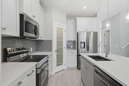 936 Reynolds Lane Sw, Airdrie, AB - Indoor Photo Showing Kitchen With Double Sink With Upgraded Kitchen