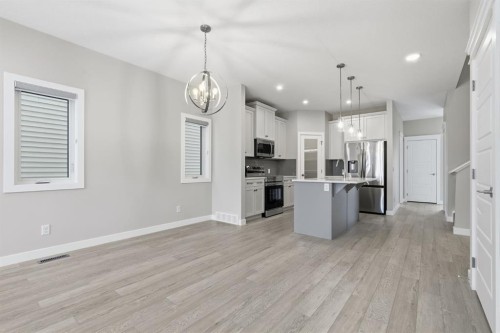 936 Reynolds Lane Sw, Airdrie, AB - Indoor Photo Showing Kitchen With Upgraded Kitchen