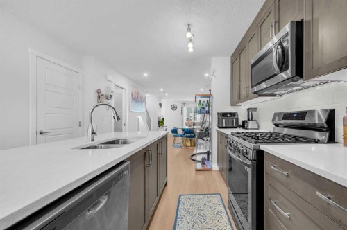 304-474 Seton Circle Se, Calgary, AB - Indoor Photo Showing Kitchen With Double Sink