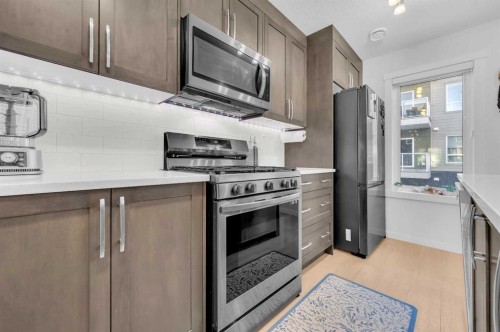 304-474 Seton Circle Se, Calgary, AB - Indoor Photo Showing Kitchen With Upgraded Kitchen