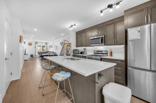 304-474 Seton Circle Se, Calgary, AB - Indoor Photo Showing Kitchen With Double Sink With Upgraded Kitchen