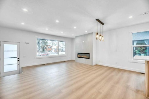 32 Allandale Close Se, Calgary, AB - Indoor Photo Showing Living Room With Fireplace