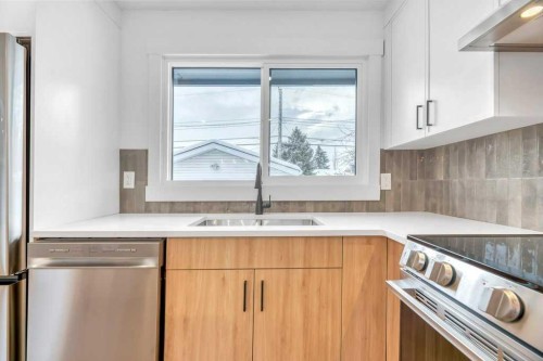 32 Allandale Close Se, Calgary, AB - Indoor Photo Showing Kitchen With Double Sink