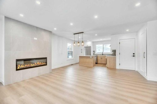 32 Allandale Close Se, Calgary, AB - Indoor Photo Showing Living Room With Fireplace