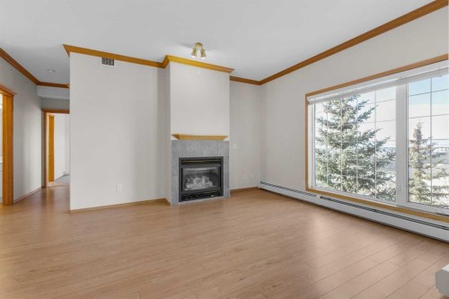 314-223 Tuscany Springs Boulevard Nw, Calgary, AB - Indoor Photo Showing Other Room With Fireplace