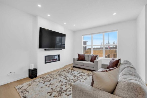 16 Magnolia Bay Se, Calgary, AB - Indoor Photo Showing Living Room With Fireplace