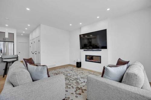 16 Magnolia Bay Se, Calgary, AB - Indoor Photo Showing Living Room With Fireplace