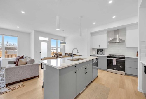 16 Magnolia Bay Se, Calgary, AB - Indoor Photo Showing Kitchen With Stainless Steel Kitchen With Double Sink With Upgraded Kitchen