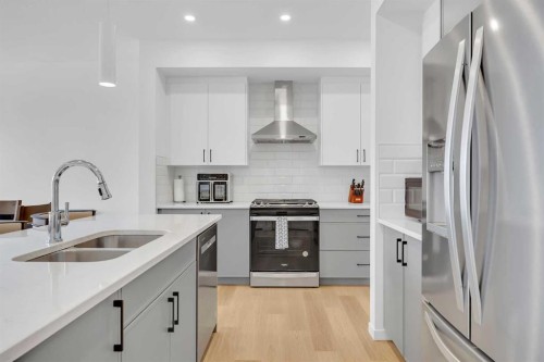 16 Magnolia Bay Se, Calgary, AB - Indoor Photo Showing Kitchen With Stainless Steel Kitchen With Double Sink With Upgraded Kitchen