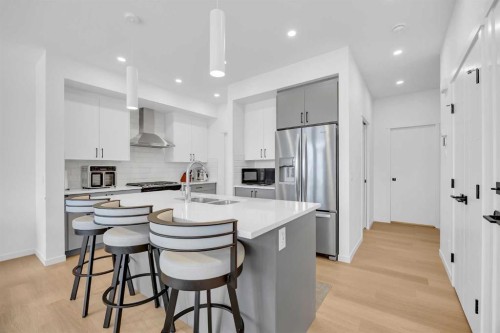 16 Magnolia Bay Se, Calgary, AB - Indoor Photo Showing Kitchen With Stainless Steel Kitchen With Double Sink With Upgraded Kitchen
