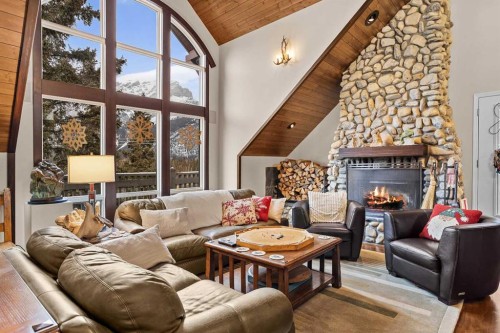 12 Antelope Lane, Banff, AB - Indoor Photo Showing Living Room With Fireplace