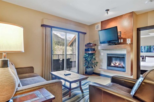 319D-1818 Mountain Avenue, Canmore, AB - Indoor Photo Showing Living Room With Fireplace