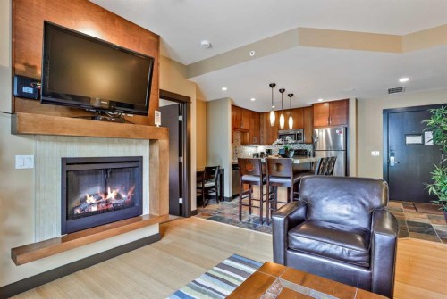 319D-1818 Mountain Avenue, Canmore, AB - Indoor Photo Showing Living Room With Fireplace