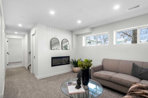 144 Deer Ridge Way Se, Calgary, AB - Indoor Photo Showing Living Room With Fireplace