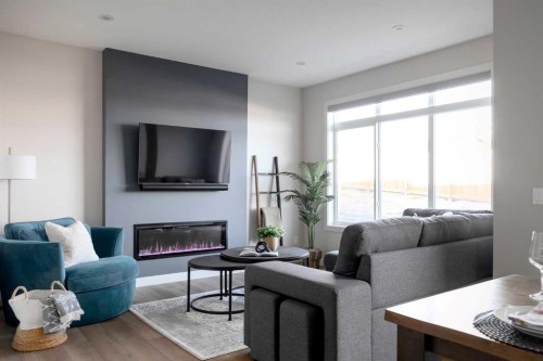87 Waterford Mews, Chestermere, AB - Indoor Photo Showing Living Room With Fireplace