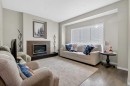 146 Marquis Common Se, Calgary, AB  - Indoor Photo Showing Living Room With Fireplace 