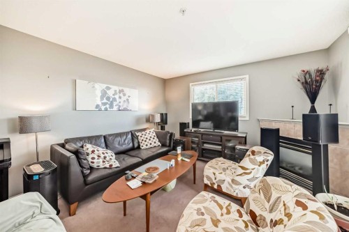 3211-4975 130 Avenue Se, Calgary, AB - Indoor Photo Showing Living Room With Fireplace