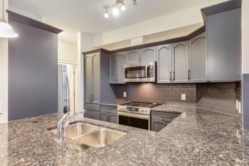 3201-4 Kingsland Close Se, Airdrie, AB - Indoor Photo Showing Kitchen With Stainless Steel Kitchen With Double Sink With Upgraded Kitchen