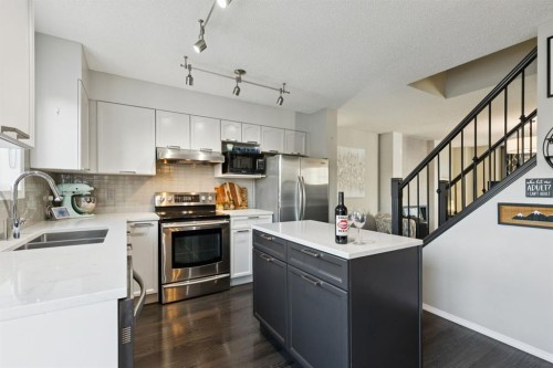 4 Copperfield Rise Se, Calgary, AB - Indoor Photo Showing Kitchen With Stainless Steel Kitchen With Double Sink