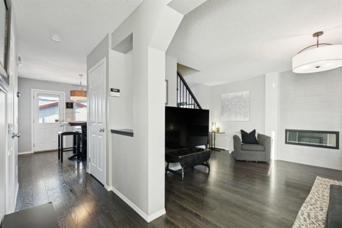 4 Copperfield Rise Se, Calgary, AB - Indoor Photo Showing Other Room With Fireplace