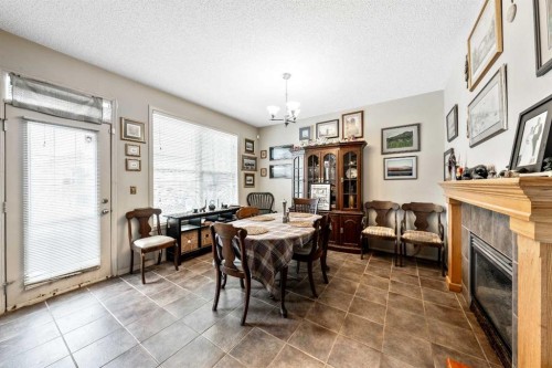 40 Mckinnon Street Nw, Langdon, AB - Indoor Photo Showing Dining Room With Fireplace