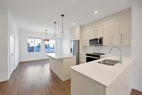 1403-280 Chelsea Road, Chestermere, AB - Indoor Photo Showing Kitchen With Stainless Steel Kitchen With Double Sink With Upgraded Kitchen