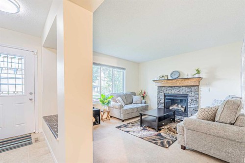 9249 Saddlebrook Drive Ne, Calgary, AB - Indoor Photo Showing Living Room With Fireplace