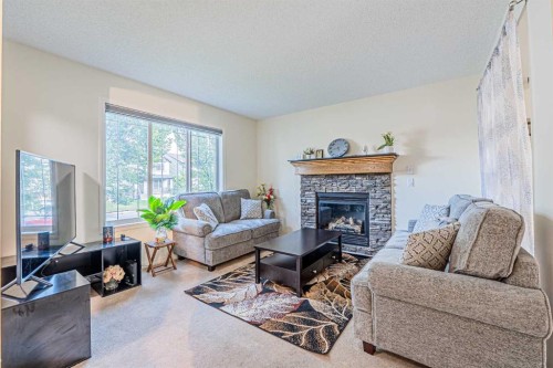 9249 Saddlebrook Drive Ne, Calgary, AB - Indoor Photo Showing Living Room With Fireplace