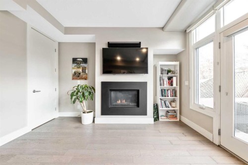 308-1611 28 Avenue Sw, Calgary, AB - Indoor Photo Showing Living Room With Fireplace