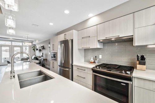308-1611 28 Avenue Sw, Calgary, AB - Indoor Photo Showing Kitchen With Stainless Steel Kitchen With Double Sink With Upgraded Kitchen