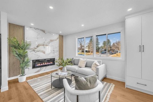 5747 24 Avenue Ne, Calgary, AB - Indoor Photo Showing Living Room With Fireplace