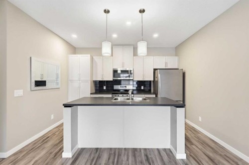 5 Copperstone Villas Se, Calgary, AB - Indoor Photo Showing Kitchen With Double Sink