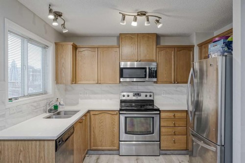 222 Bridleridge Way Sw, Calgary, AB - Indoor Photo Showing Kitchen With Double Sink
