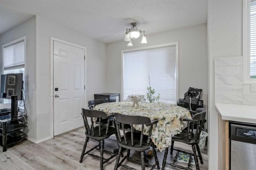 222 Bridleridge Way Sw, Calgary, AB - Indoor Photo Showing Dining Room With Fireplace