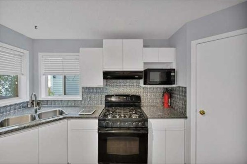 73 Hidden Spring Green Nw, Calgary, AB - Indoor Photo Showing Kitchen With Double Sink