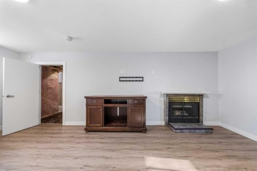 1623 Summit Street Sw, Calgary, AB - Indoor Photo Showing Living Room With Fireplace