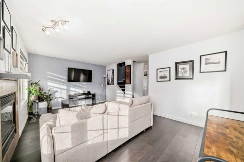128-7707 Martha'S Haven Park Ne, Calgary, AB - Indoor Photo Showing Living Room With Fireplace