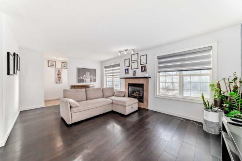 128-7707 Martha'S Haven Park Ne, Calgary, AB - Indoor Photo Showing Living Room With Fireplace