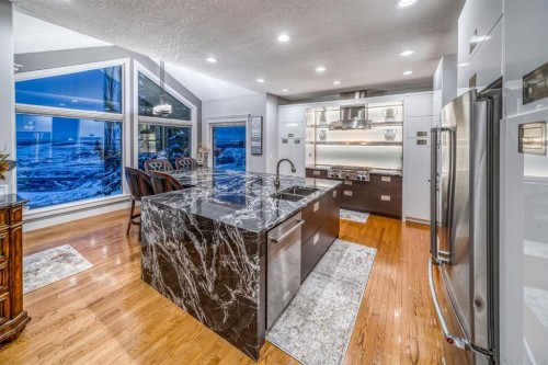 158 Gleneagles View, Cochrane, AB - Indoor Photo Showing Kitchen With Double Sink With Upgraded Kitchen