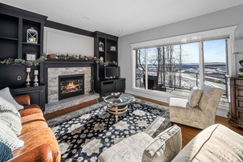 158 Gleneagles View, Cochrane, AB - Indoor Photo Showing Living Room With Fireplace